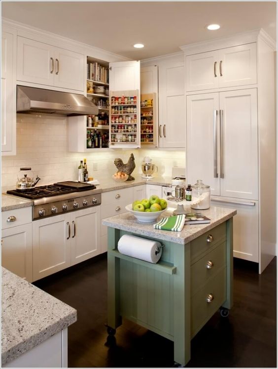 a tiny green kitchen island on casters with drawers and holders plus a stone countertop