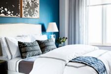 10 a monochromatic bedroom is infused with color – a bold blue accent wall that makes it vivacious