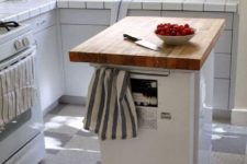 10 a portable dishwasher kitchen island with a butcher block countertop and holders is a functional option