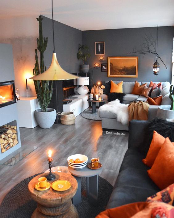 a space done in grey shades and enlivened with bold orange touches in each corner