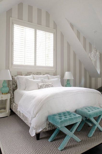 an attic bedroom in white, grey as a secondary color and touches of turquoise here and there