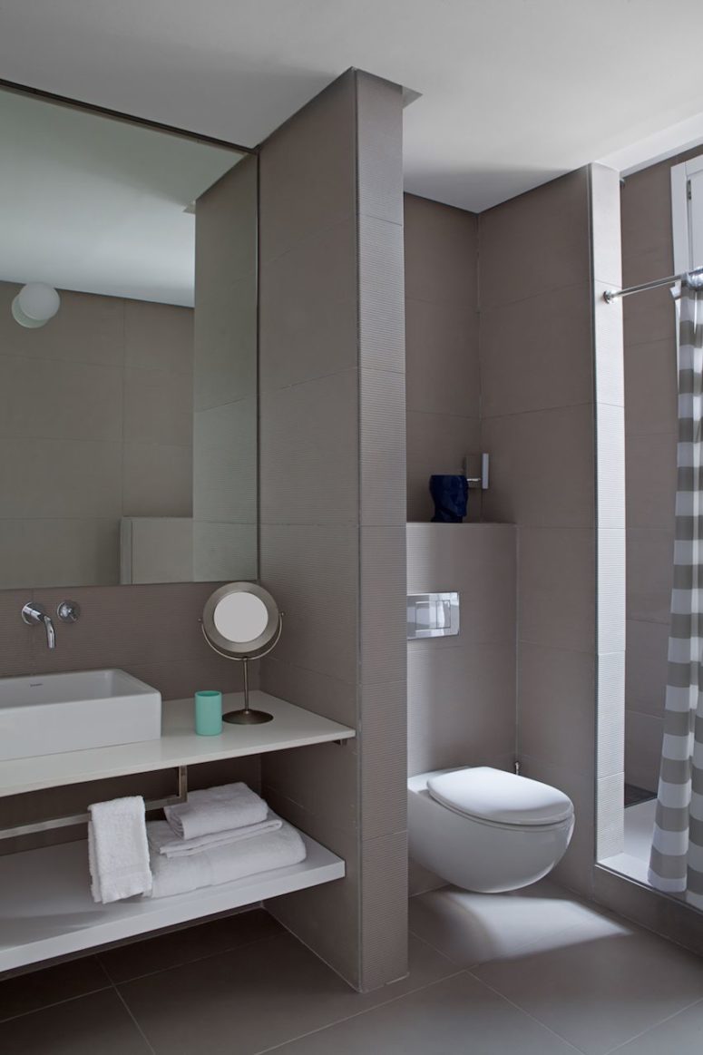 The bathroom is soothing and minimalist