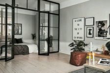 11 a living room and bedroom separated with a glass wall look as a stylish unity