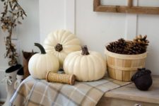 11 a simple display with a basket of pinecones, some white pumpkins and cotton in a pallet box