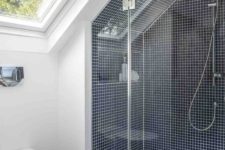 11 tiny square navy tiles with white grout to highlight the alcove shower space