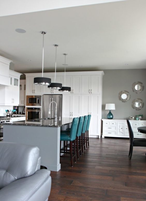 Touches of teal in each space of this stylish open layout enliven it and make it bolder