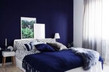 12 a bold blue accent wall plus a matching pillow and a fringed blanket for a wow effect