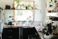12 a kitchen with lots of plants, a boho rug and wooden shelves for a natural feel