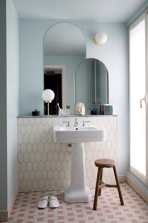 a pale blue wall and a creamy tile accent for a subtle and delicate look in your bathroom