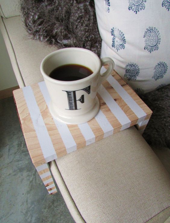A small sofa caddy with stripes is nice to hold a drink or a small gadget of your choice