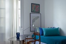 13 The guest bedroom features a comfy daybed, artworks and a vintage chair plus a modern desk