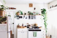 13 a small and light-filled boho kitchen with potted greenery, wooden and wicker touches looks very welcoming