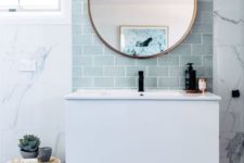 13 an aqua blue tile accent on the wall highlights the mirror and the floating vanity