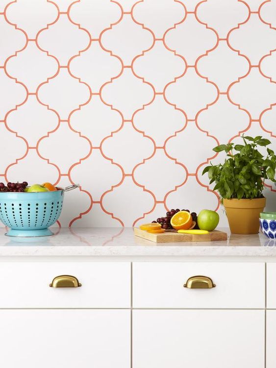 white arabesque tiles for the kitchen backsplash and bold orange grout to highlight it