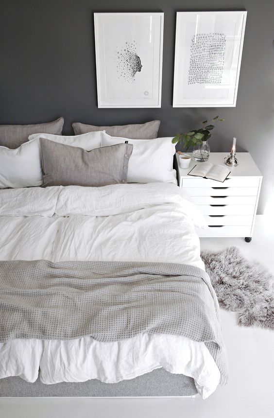 a bedroom in the shades of grey mixed with crispy white and spruced up with artworks