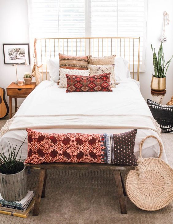 a straw round bag, bright printed pillows and fringed items for a boho chic space