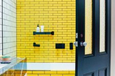 14 bold yellow tiles with navy grout and navy fixtures plus a navy door to continue the theme