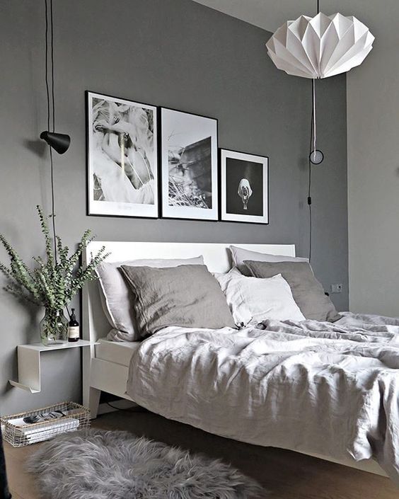 a bedroom in various grey shades with a black and white gallery wall for a bold touch