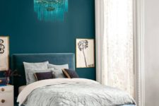 15 a bold teal wall for a statement and a dusty blue upholstered bed plus a matching ottoman