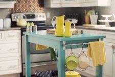 15 a bright turquoise kitchen island with a shelf and some holders adds color to the space