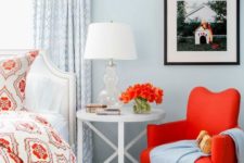 16 a hot red chair on wooden legs adds to the powder blue coastal bedroom
