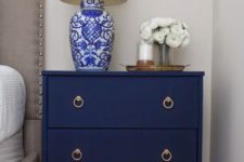 16 a navy fabric covered nightstand with elegant handles is a chic idea for any bedroom