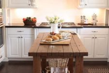 16 a rustic wood kitchen island contrasts white cabinets and features storage space underneath
