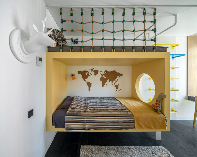 The first kid's room is done with a creative bed with a climbing net on top