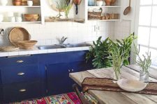 17 a boho chic kitchen with wooden and wicker touches plus a colorful boho rug and bold cabinets