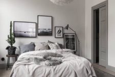 17 a chic gallery wall in black frames is what makes this grey bedroom eye-catchy