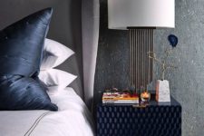 17 a cool textural navy nightstand adds an interesting touch to the space