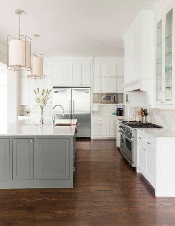 a traditional white kitchen with a grey kitchen island that adds a touch of color but not too much