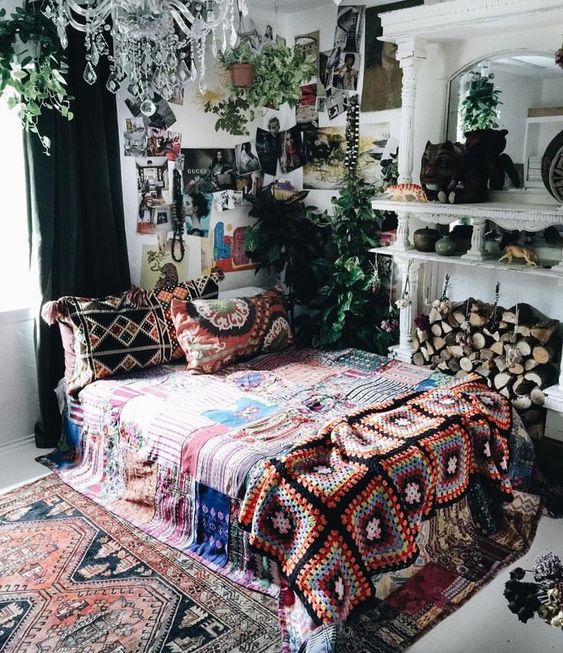 bold boho chic textiles and rugs, some artworks and greenery for a boho yet glam look