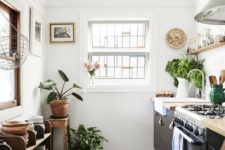 18 a boho chic kitchen with wooden touches and a boho rug plus potted greenery