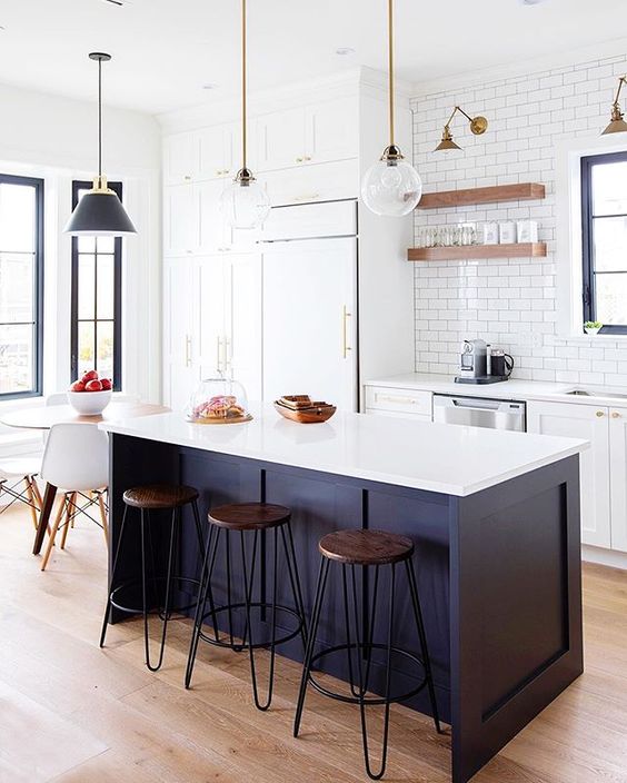 a white kitchen and a midnight blue kitchen island with a white countertop for a chic and catchy look