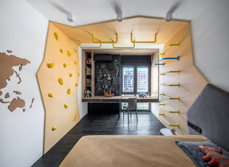 The second kid's room is similar, also done in grey and bright yellow, with a chalkboard wall and a study space