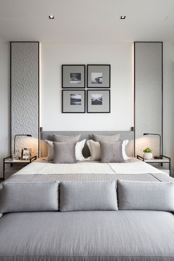 a gallery wall over the bed and cool upholstered panels on each side of the bed