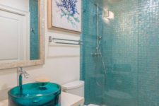 19 a turquoise glass sink and a matching vanity plus a tile shower wall is a great color statement