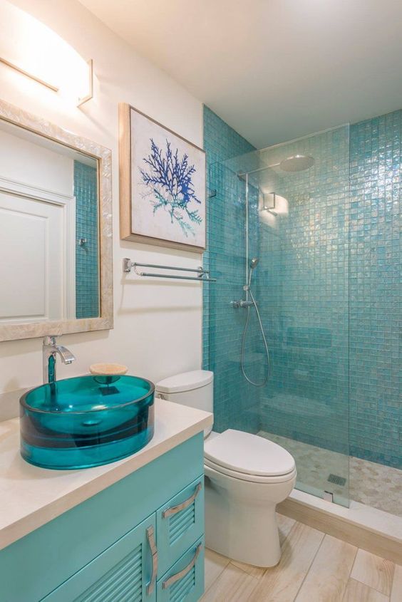 a turquoise glass sink and a matching vanity plus a tile shower wall is a great color statement