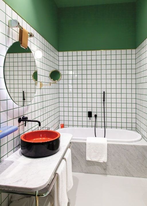 emerald grout and a painted half wall and a ceiling for a trendy and colorful bathroom
