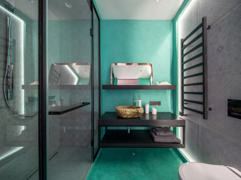 The kids' bathroom is done in black, white and bright turquoise to make it more welcomign for kids yet cheerful