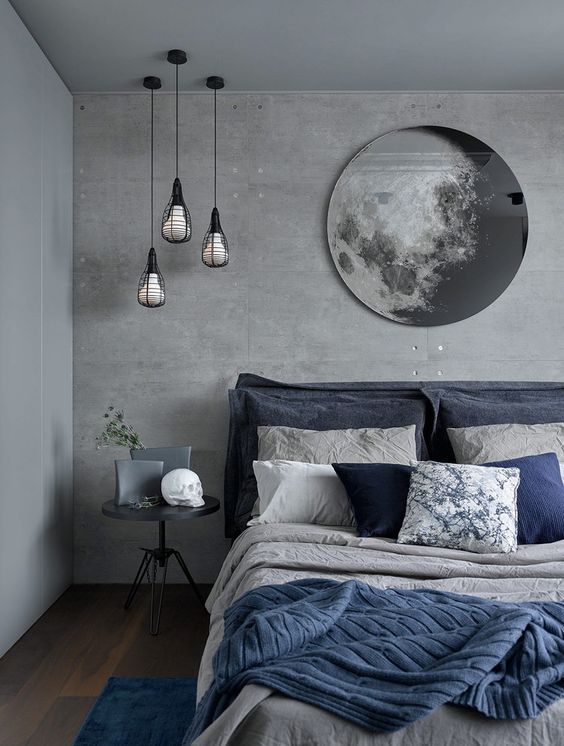 a chic grey and navy bedding set plus a blue rug enliven the grey bedroom