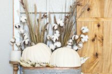 20 a farmhouse display with white pumpkins, wheat and cotton in a metal bathtub