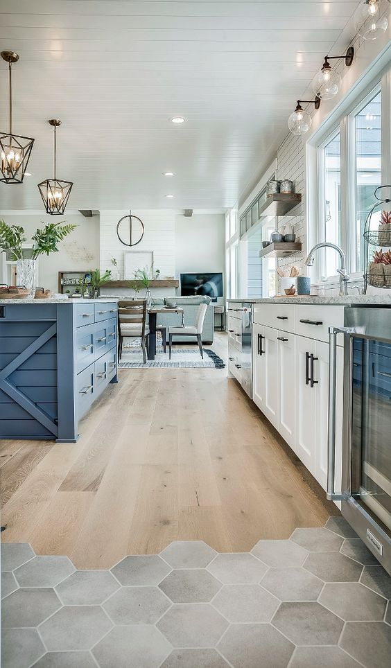 add color to your space with a different kitchen island like here - a blue farmhouse piece to a white kitchen