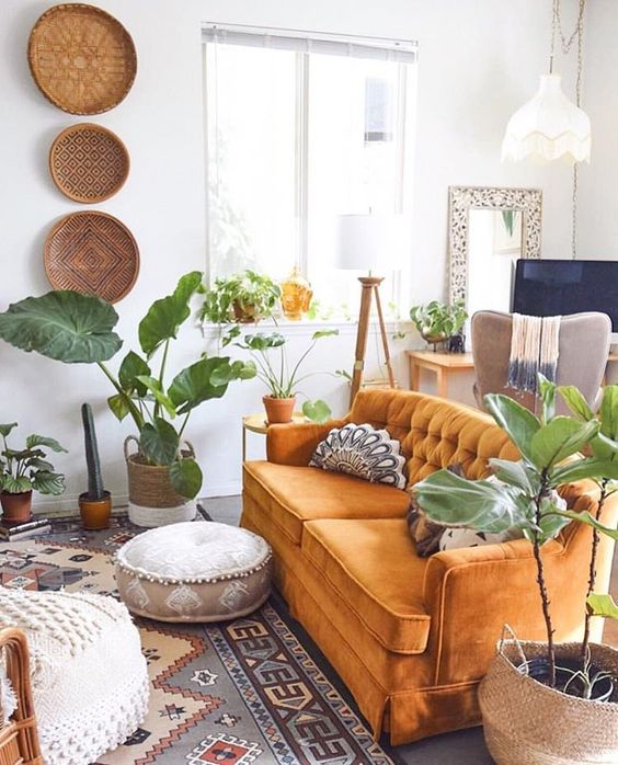 lots of potted greenery and boho baskets on the wall plus boho textiles for a free-spirited space
