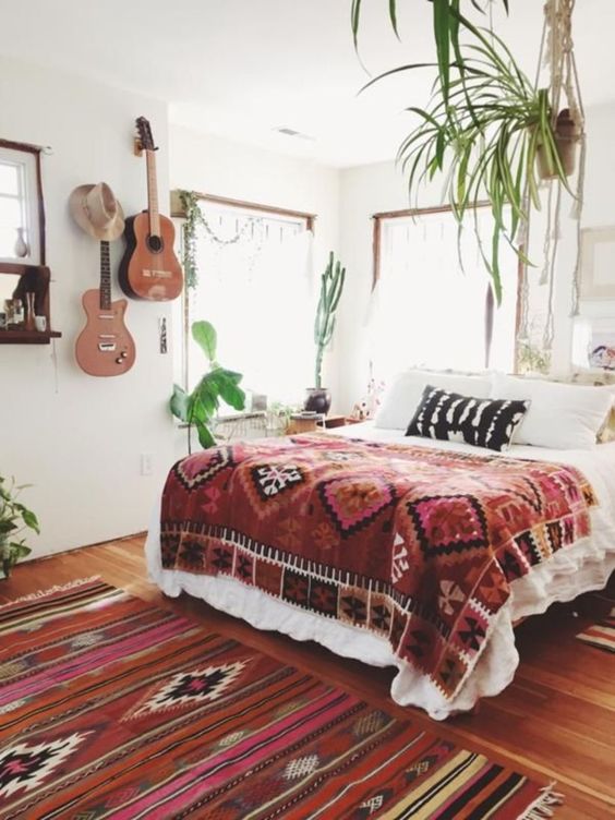 Potted greenery, boho textiles and real guitars hanging on the wall for a free spirited touch