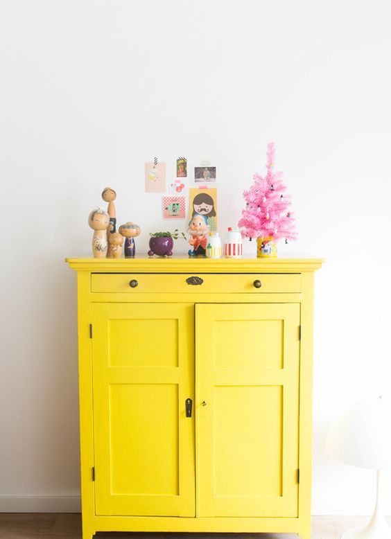 a bright yellow cabinet is a nice idea to add color and make an accent