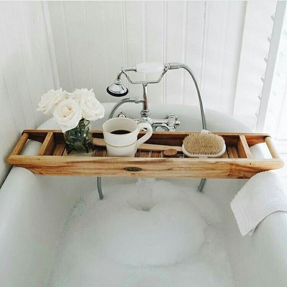 a modern wooden caddy with handles and a deep tray adds a spa feel to the bathroom