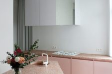21 blush kitchen cabinets with terrazzo countertops and white upper cabinets for a trendy look