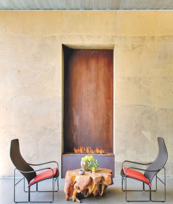 a luxurious fire pit space with a unique coffee table and creative bold chairs